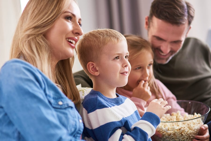 A family sharing popcorn on movie night