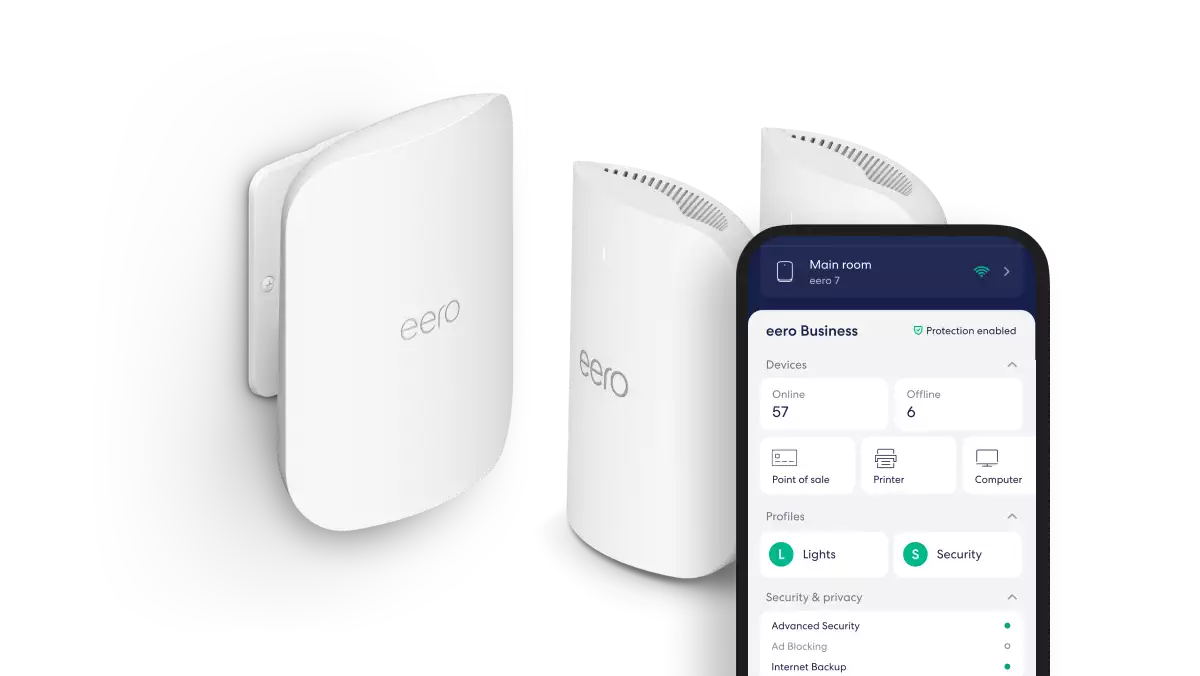 eero WiFi 7 access points beside a phone showing the eero Business app with devices online and security enabled