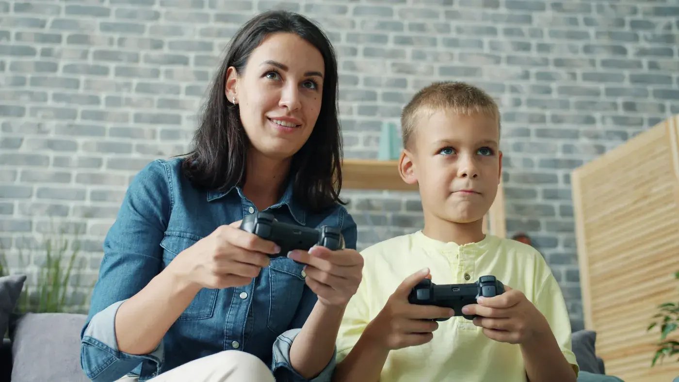 Mom and son focused on a video game