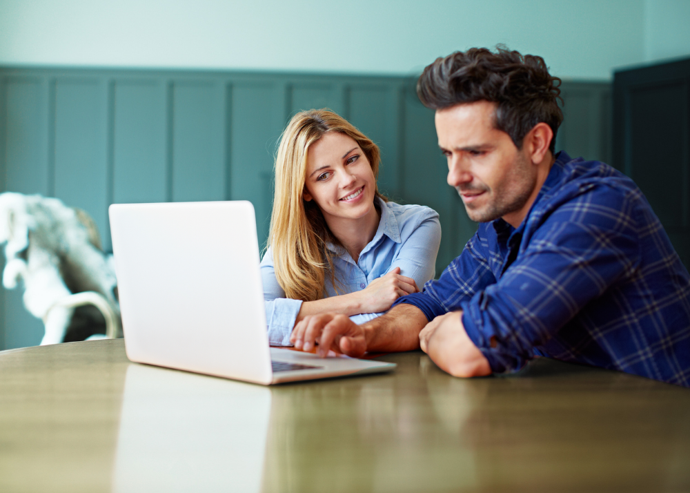 A woman and man enjoy fast fiber internet at home.