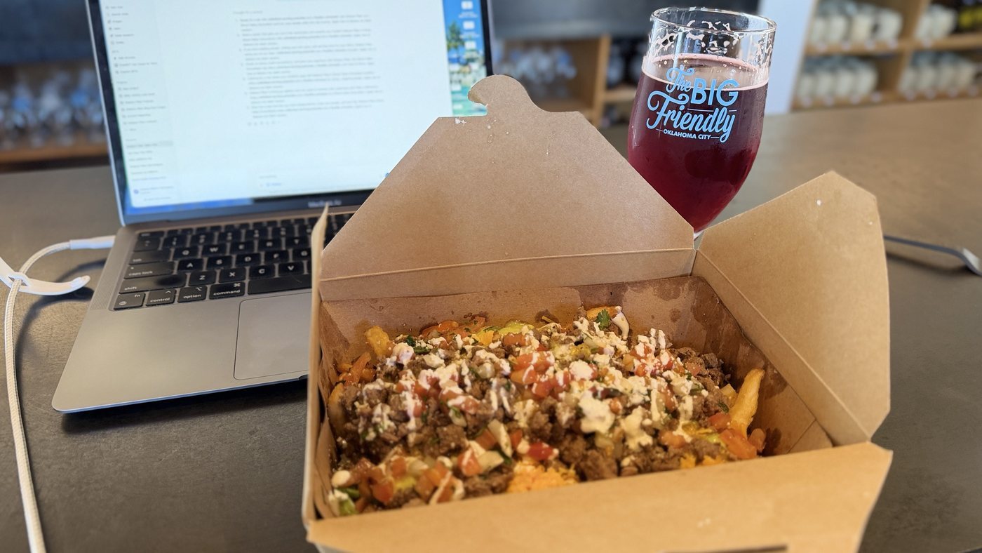 Loaded fries and a ruby-red pour in a Big Friendly glass
